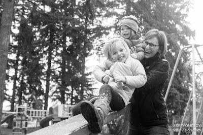 Child on Slide with Parents